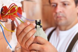 Electricians Performing Electrical Inspection On Home