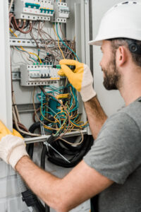 electrician repairing electrical box components